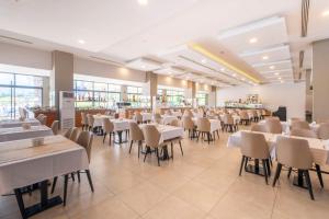 une salle à manger avec des tables et des chaises blanches dans l'établissement Viking Park Hotel, à Kemer