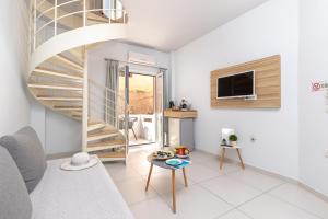 a living room with a spiral staircase and a tv at Notus Chania Crete in Chania Town