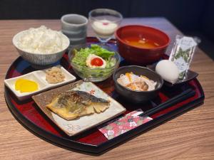 a tray with food on a wooden table at Henn na Hotel Komatsu Ekimae in Komatsu