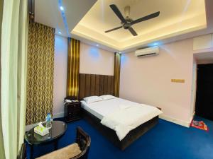 a bedroom with a bed and a ceiling fan at Hotel Grand Akther in Sylhet