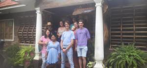 a group of people standing on the porch of a house at Sopanam Heritage Thekkady in Thekkady