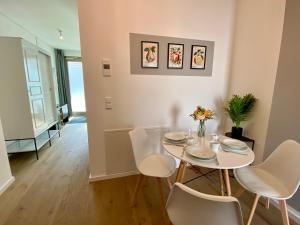 a dining room with a white table and chairs at Apartment am Lutherplatz in Potsdam