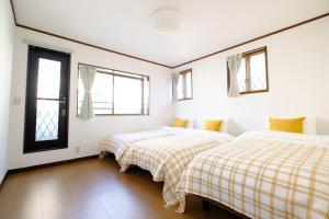 Krevet ili kreveti u jedinici u okviru objekta Villa Hiratsuka ツバメキタル-Vacation STAY