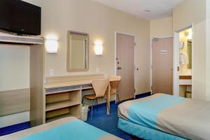 a hotel room with a desk and a bed at Motel 6-Peterborough, ON in Peterborough