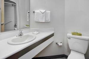 a white bathroom with a sink and a toilet at Motel 6-Peterborough, ON in Peterborough