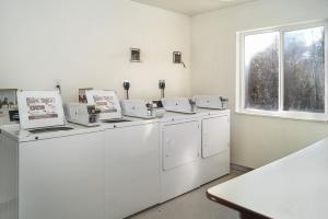 a laundry room with white machines and a window at Motel 6-Peterborough, ON in Peterborough