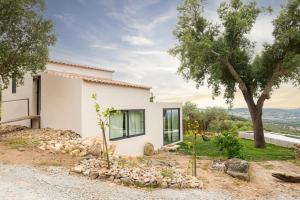 a white house with a tree in front of it at Vigias -Eternal Landscapes in Marvão