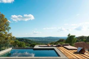 a swimming pool with a view of the mountains at Vigias -Eternal Landscapes in Marvão