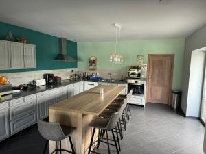 a large kitchen with a wooden table and chairs at Chambre de la Wamme 2 in Marche-en-Famenne