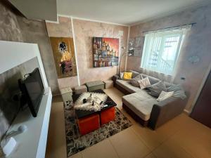 a living room with a couch and a tv at La casa di Elena in Sannicandro di Bari