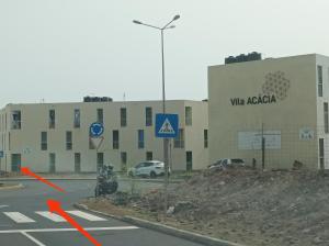 a building with a sign on the side of a road at Casa Do Encanto in Praia