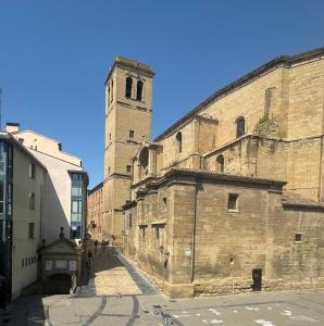 an old building with a clock tower on a street at Santiago Tower View Aire Acondicionado, casco antiguo in Logroño