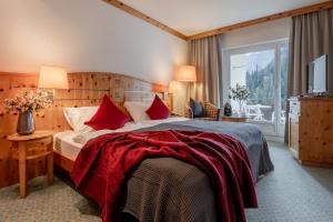 A bed or beds in a room at AROSA ALPINE CLUB - Adults only