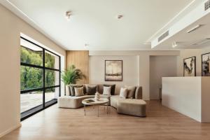 a living room with a couch and a table at Solridge Aparthotel in Tbilisi City