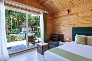 Krevet ili kreveti u jedinici u okviru objekta Stone Wood Jungle Resort, Dandeli