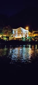 a building next to a body of water at night at Beachfront Villa Nautica in Kotor