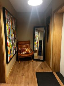 a hallway with a chair and a mirror at Business and getaway in Jelgava