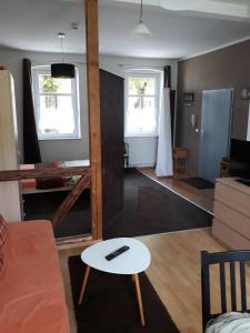 a living room with a couch and a table at Allsaitig Klang- und Seminarzentrum Selb in Selb