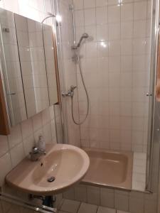 a bathroom with a sink and a shower and a tub at Allsaitig Klang- und Seminarzentrum Selb in Selb