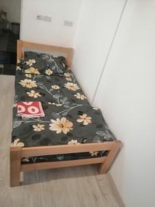 uma cama num quarto com flores em Sindi Apartman em Bačka Palanka