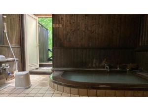 a bath tub in a bathroom with a sink at Shinyu Onsen Kurikomaso - Vacation STAY 04615v in Kurihara