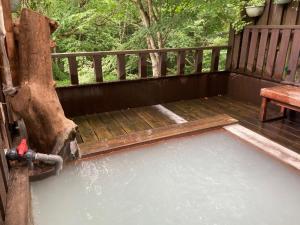 a pool of water on a porch with a bench at Shinyu Onsen Kurikomaso - Vacation STAY 04615v in Kurihara