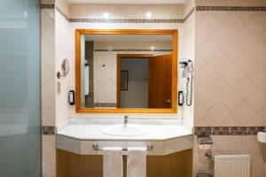 La salle de bains est pourvue d'un lavabo et d'un miroir. dans l'établissement Hotel IPV Palace & Spa - Adults Recommended, à Fuengirola