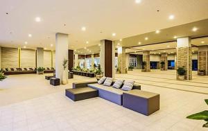 a lobby with couches and chairs in a building at studio room seaview jomtien in Jomtien Beach