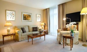 a living room with a couch and a table at Hotel Le Plaza Brussels in Brussels