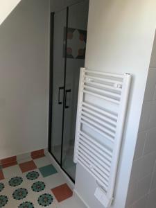 a shower with a glass door in a bathroom at Longue Vue en Arbois in Arbois