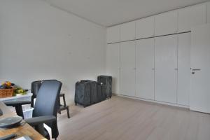 an office with white cabinets and a table and chairs at Come in! "Pirkanportti" In the heart of Tampere next to the railway station for 9 people! in Tampere