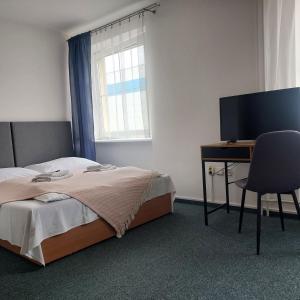 Postelja oz. postelje v sobi nastanitve Garni G Hotel Žilina