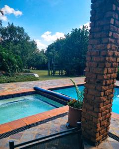 The swimming pool at or close to Cycad Place Midrand Guesthouse and B&B