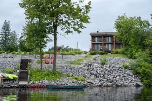 ein Haus am Ufer eines Wasserkörpers in der Unterkunft Ramada by Wyndham Ottawa On The Rideau in Ottawa