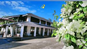 a house with a kite flying in the sky at Saaranga homestay in Avathi