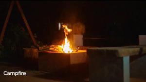 a fire pit at night with flames in it at Saaranga homestay in Avathi