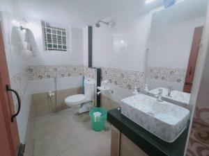 a bathroom with a sink and a toilet at V4 Stay - Luxury 1 BHK AC Suite sleeps 5 guests in Coimbatore