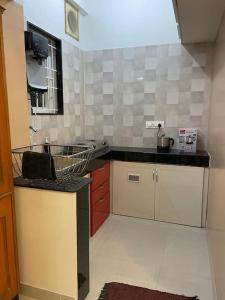 a kitchen with a sink and a counter top at V4 Stay - Luxury 1 BHK AC Suite sleeps 5 guests in Coimbatore