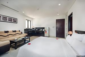 A bed or beds in a room at Dylan Hotel Danang