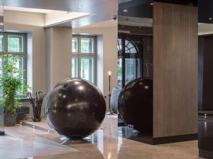 two large black spheres in a room with windows at Pullman Riga Old Town in Rīga