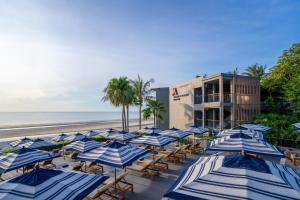 um monte de guarda-sóis azuis e brancos numa praia em Hua Hin Marriott Resort and Spa em Hua Hin