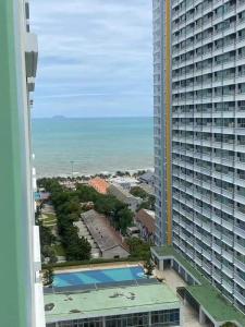 a view of a large building and a swimming pool at studio room seaview jomtien in Jomtien Beach