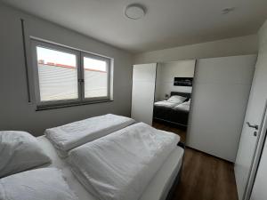 a bedroom with two beds and a window at Fewo Altes Rathaus in Bamberg