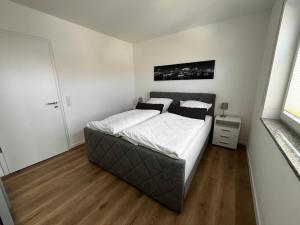 a bedroom with a large bed with white sheets at Fewo Altes Rathaus in Bamberg