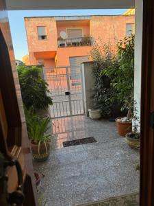 an open door to a courtyard with plants and a building at Da Gio in Olbia