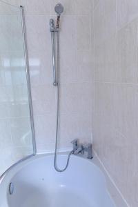 a shower in a bathroom with a tub at 3 Bedroom House Manchester Free Wifi and Parking in Manchester