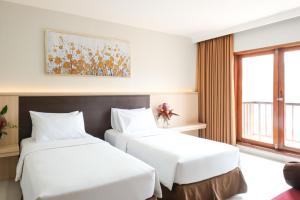 Tempat tidur dalam kamar di The Grand Hill Resort-Hotel