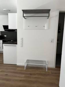 a white kitchen with a bench in a room at Fewo Altes Rathaus in Bamberg