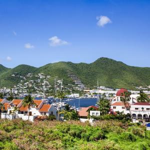 a view of a town with a harbor and mountains at Commodore Suites in Simpson Bay