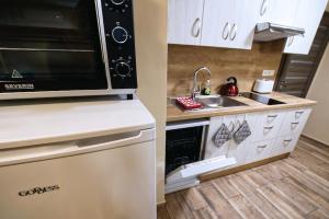 a small kitchen with a sink and a microwave at Nice accommodation in Mikulov in Mikulov